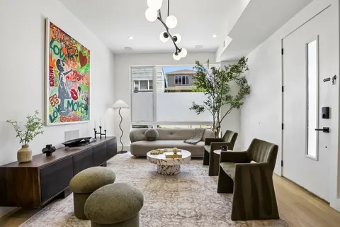 a living room with furniture and flowers
