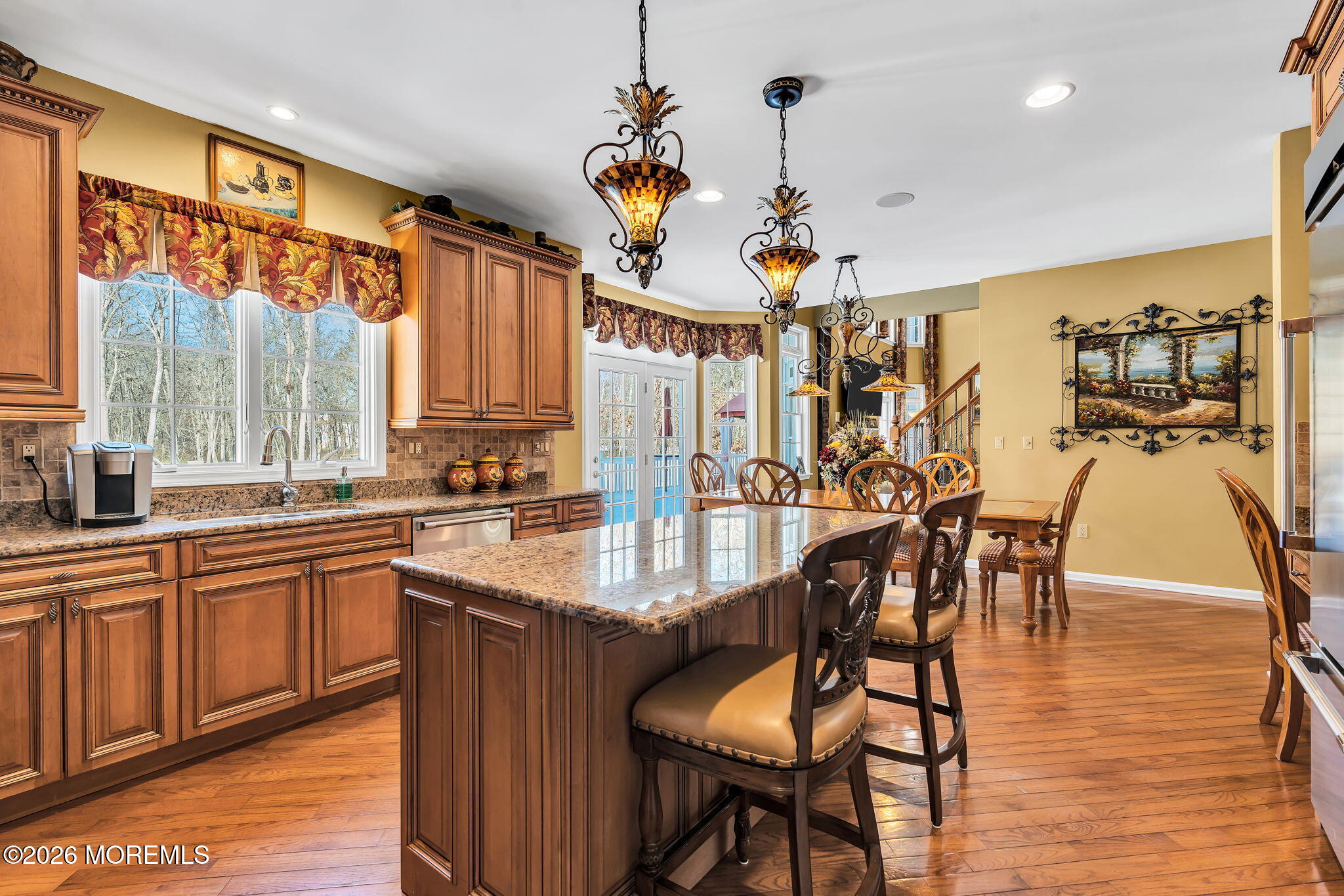 24 Parkside Drive Jackson, NJ 08527 - Photo 44 of 91 a kitchen with stainless steel appliances granite countertop a table chairs sink and wooden floor