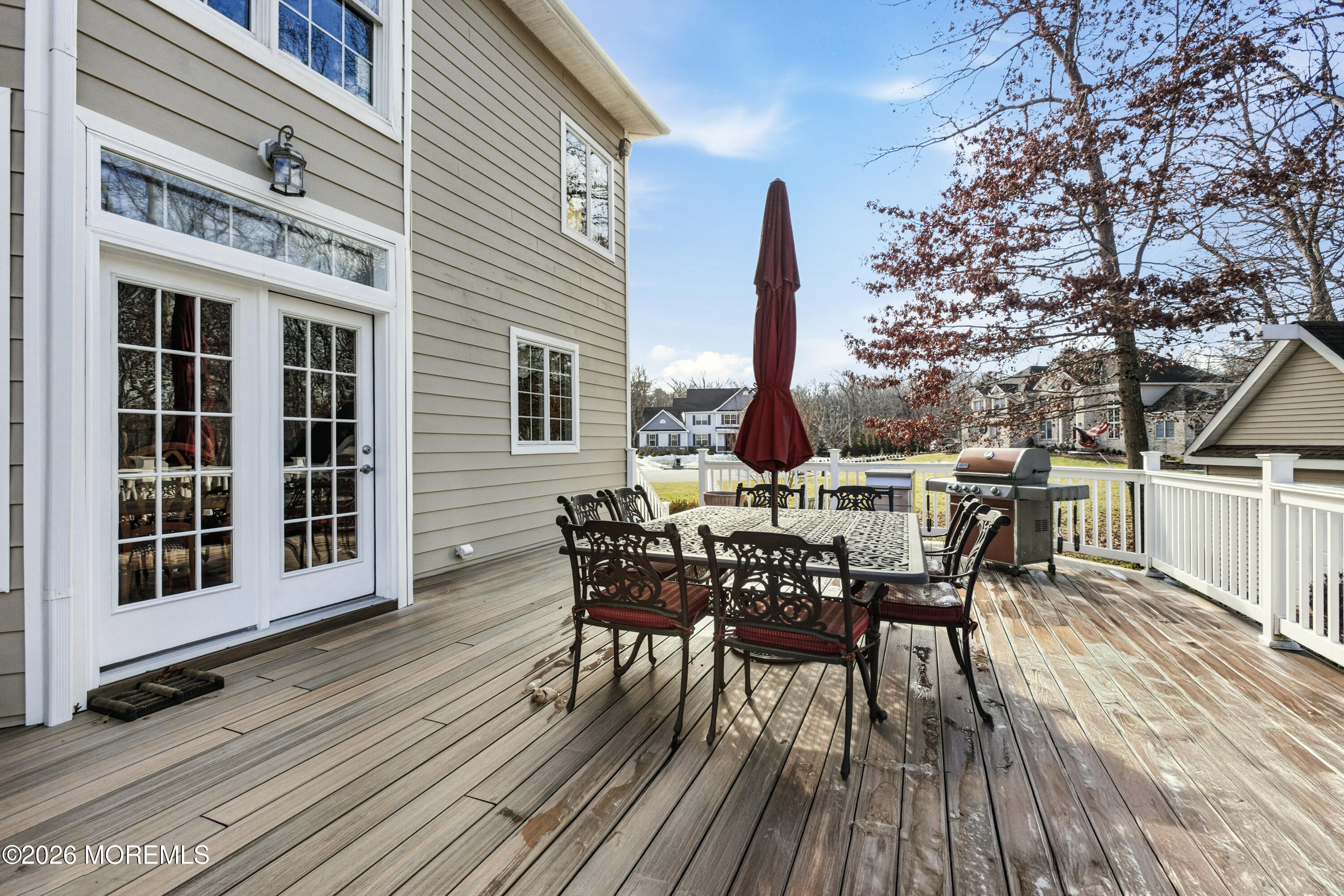 24 Parkside Drive Jackson, NJ 08527 - Photo 91 of 91 a view of a roof deck with table and chairs floor to ceiling window with wooden floor