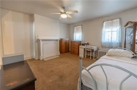 a spacious bedroom with a bed and a chandelier