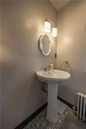 a bathroom with a sink a mirror and a toilet