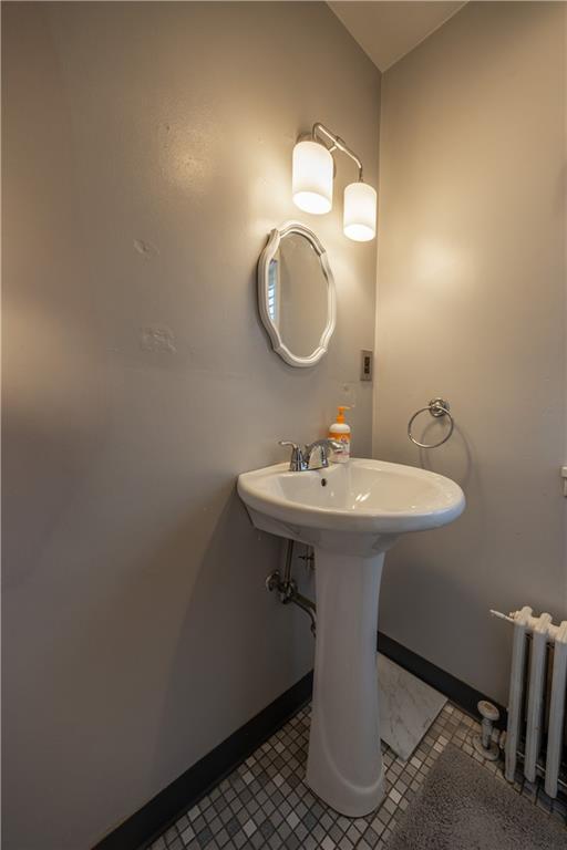 3245 Juliet Street Pittsburgh, PA 15213 - Photo 19 of 22 a bathroom with a sink a mirror and a toilet