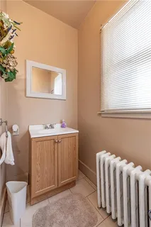 a bathroom with a sink mirror vanity and toilet