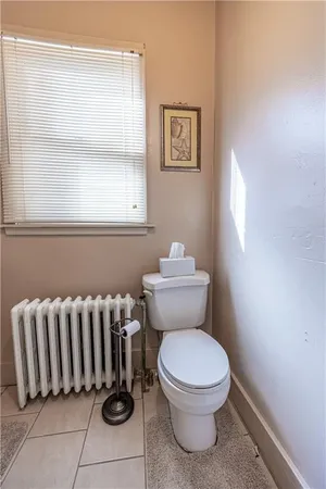 a bathroom with a toilet and a window