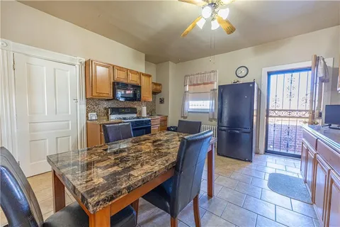 a kitchen with a table and refrigerator