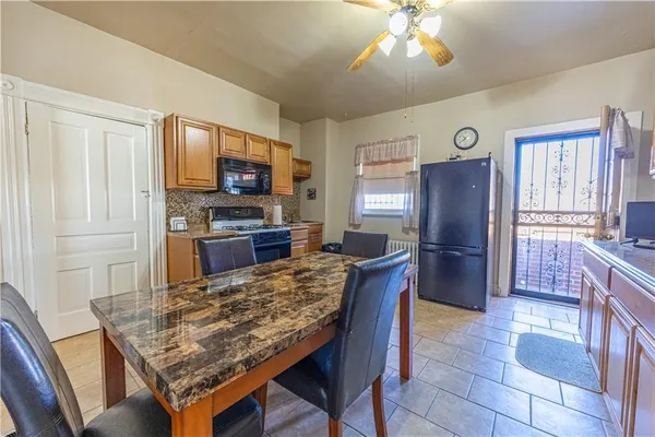 a kitchen with a table and refrigerator
