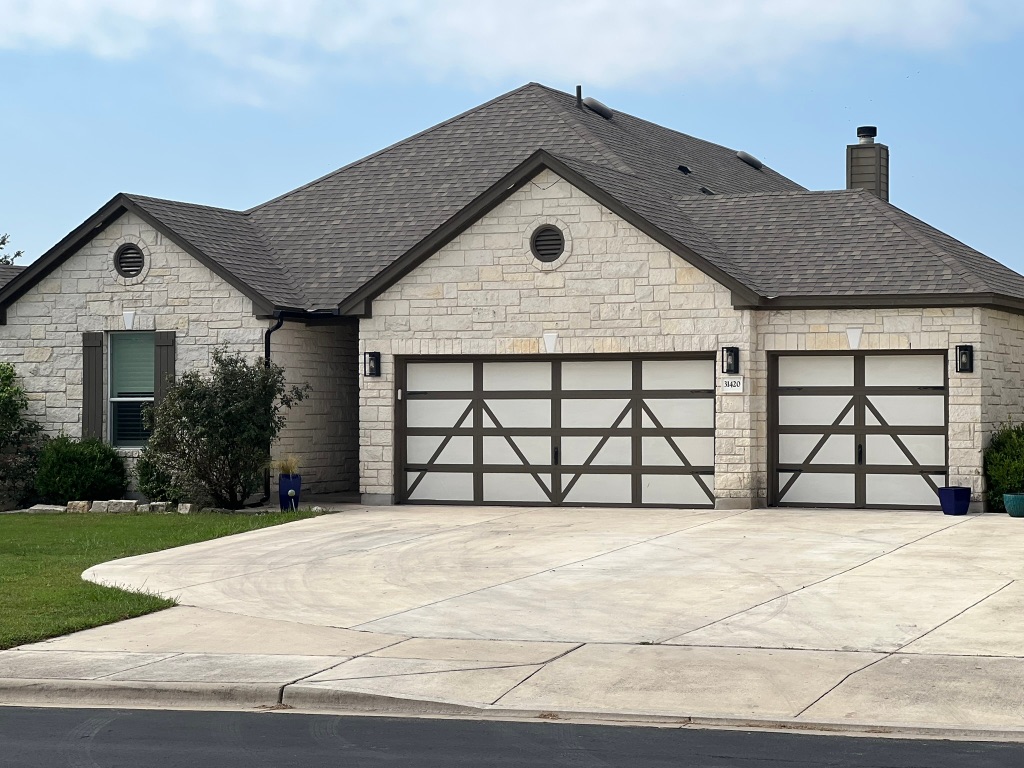 a front view of a house with a yard and garage