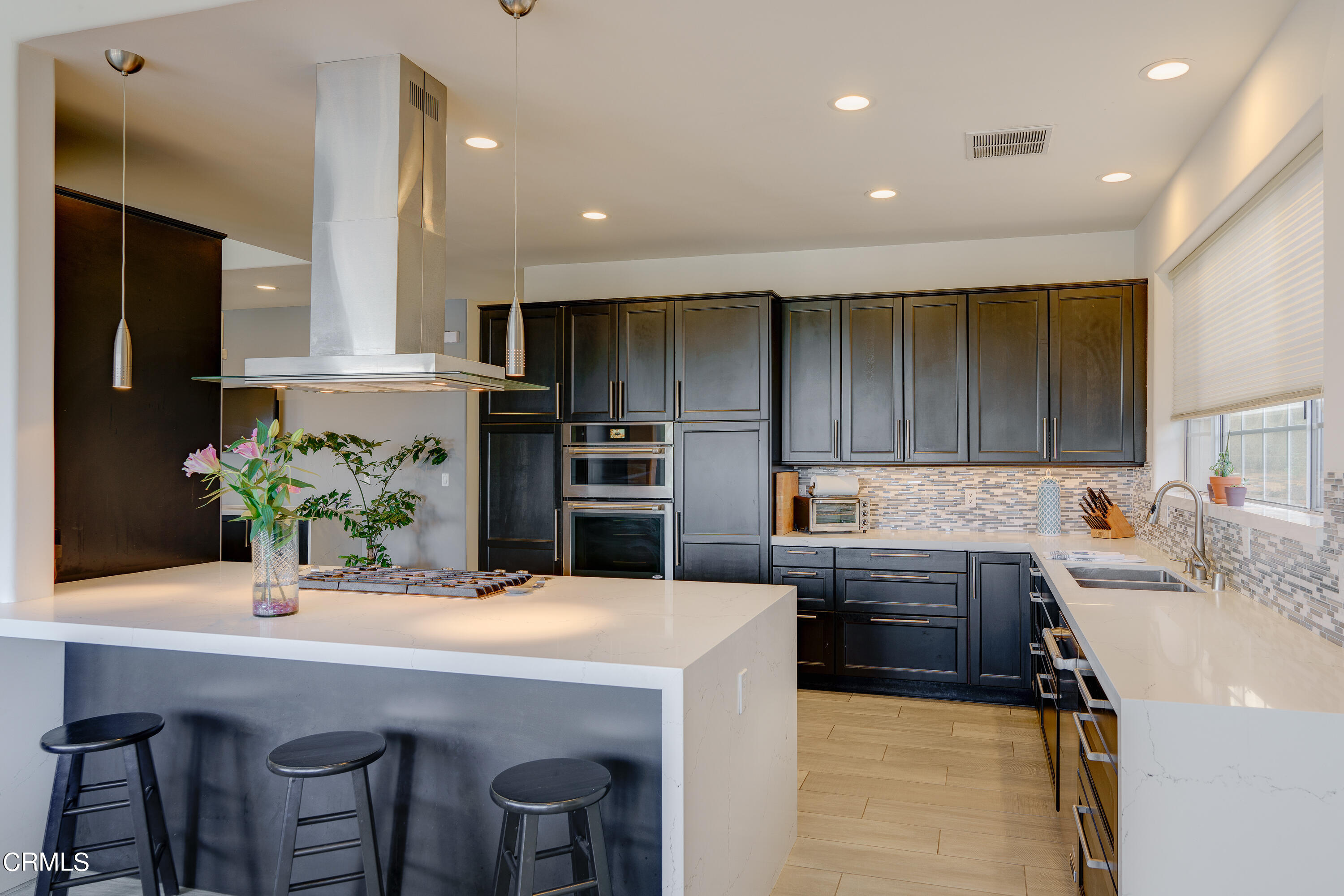 3336 Stephens Circle Glendale, CA 91208 - Photo 34 of 74 a kitchen with kitchen island a refrigerator and a stove top oven
