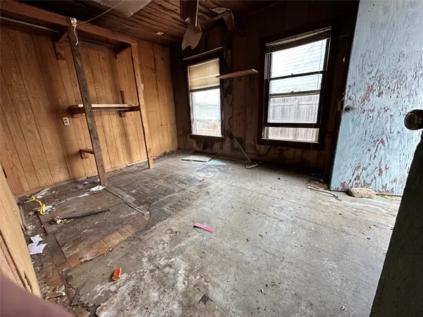 a view of a hallway with wooden walls