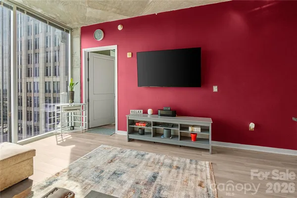 a living room with furniture and kitchen view