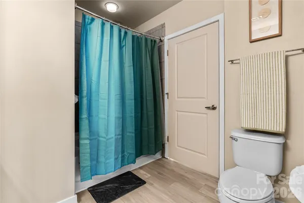 a bathroom with a granite countertop sink mirror vanity and toilet
