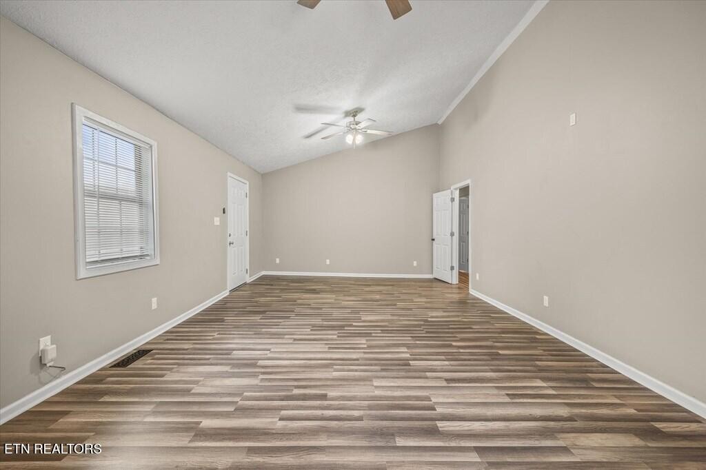 518 Flatt Spur Road Jamestown, TN 38556 - Photo 17 of 30 a view of empty room with wooden floor and fan
