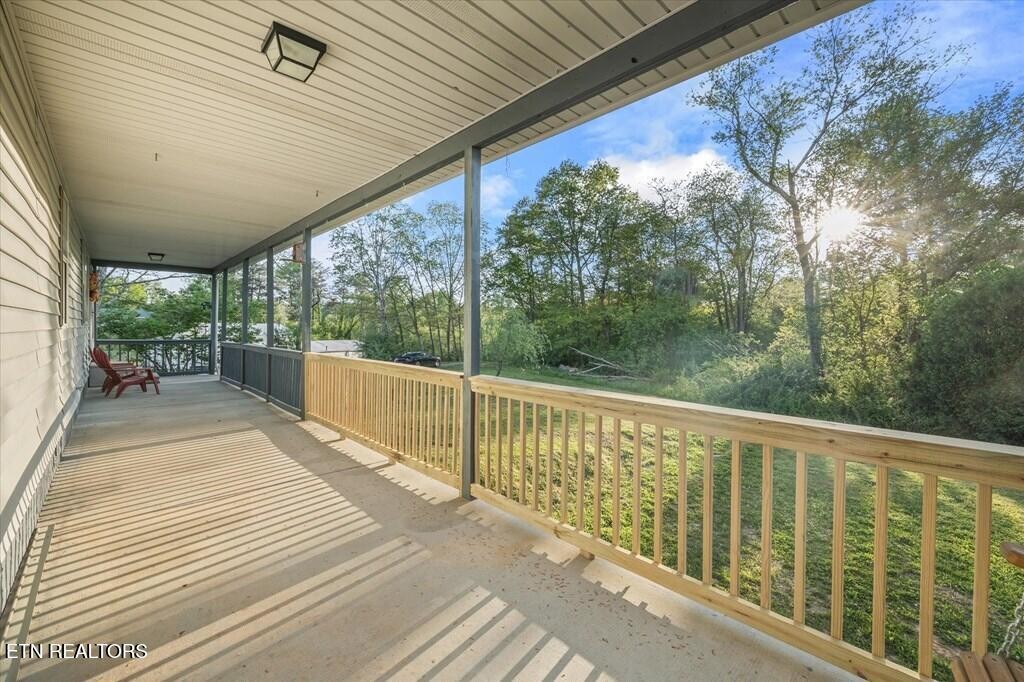 518 Flatt Spur Road Jamestown, TN 38556 - Photo 3 of 30 a balcony with wooden floor and outdoor space