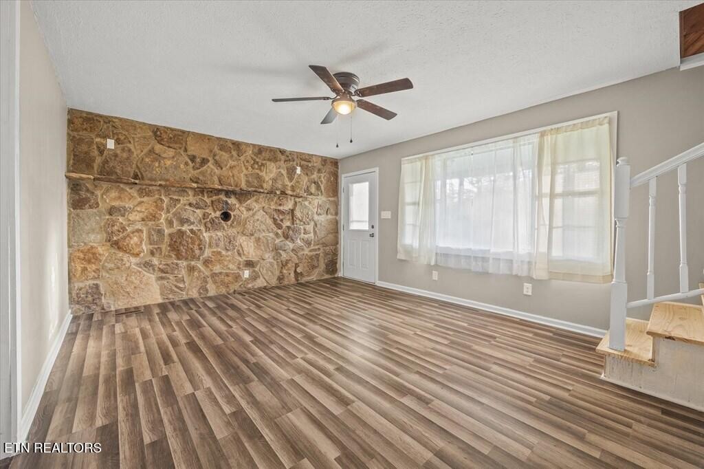 518 Flatt Spur Road Jamestown, TN 38556 - Photo 10 of 30 a view of an empty room with a window and wooden floor