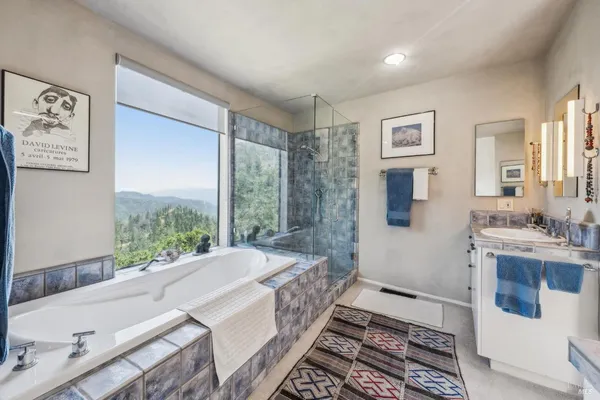 a view of a dry field with mountains in the background