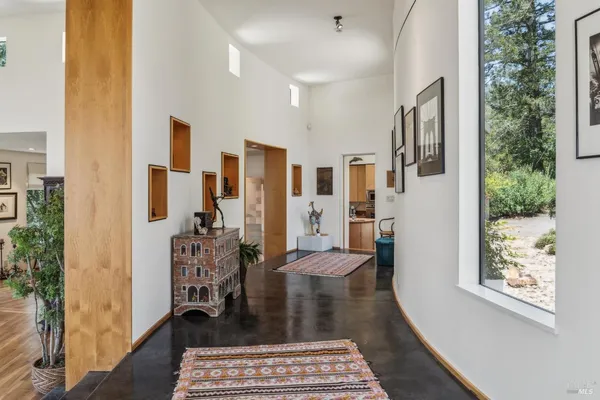 a living room with furniture gym equipment and a large window