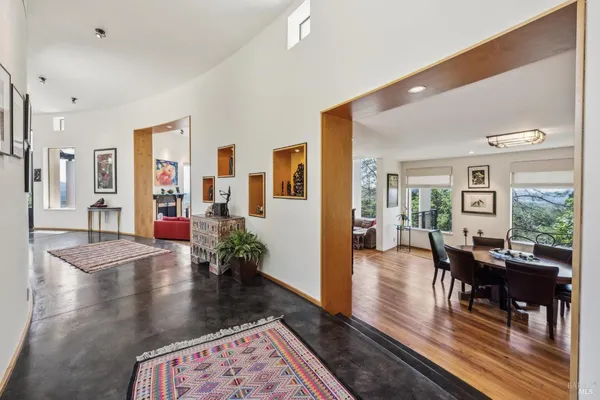 a living room with furniture fireplace and a large window