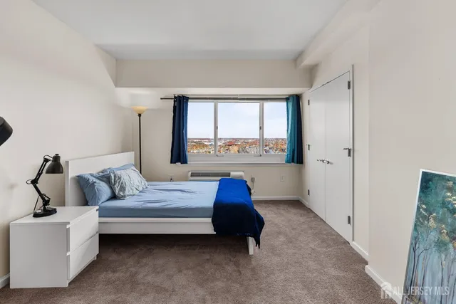 a bedroom with a bed and a large window