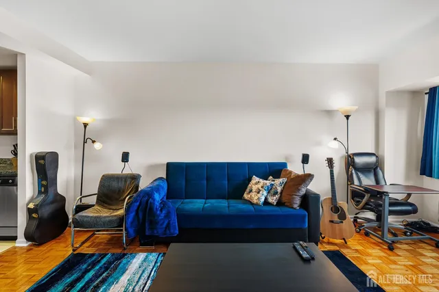 a living room with furniture a rug and a flat screen tv