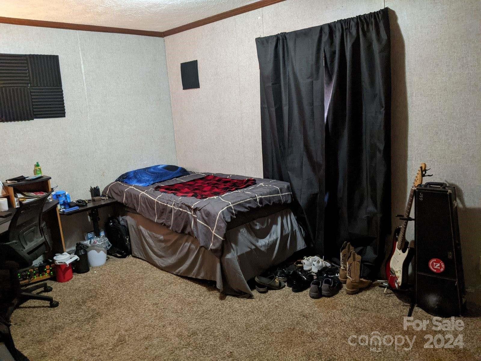 5059 Cabal Road Sharon, SC 29742 - Photo 23 of 36 a bedroom with a bed and a mirror