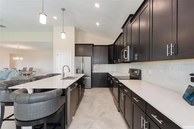 a view of a dining room with furniture and a chandelier