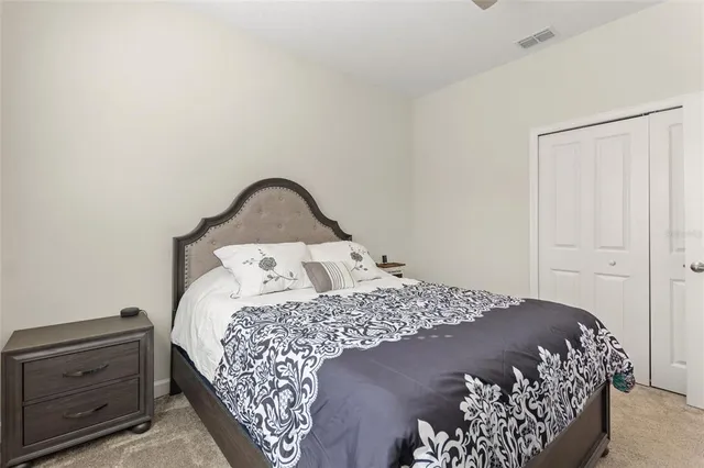 a bed sitting in a bedroom next to a window