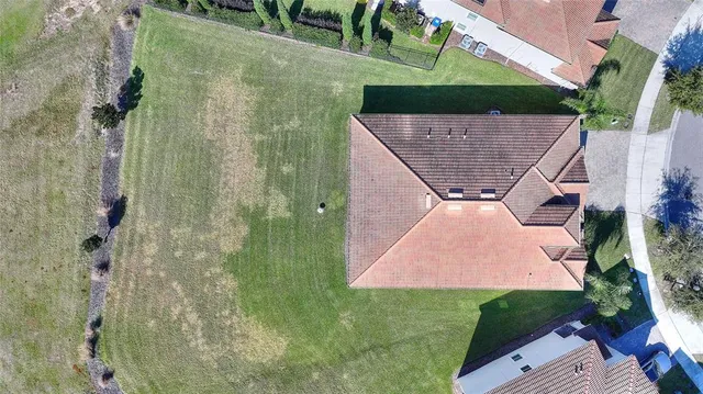 an aerial view of a house with a swimming pool patio and outdoor seating