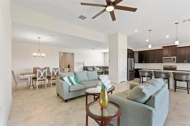 a kitchen with stainless steel appliances granite countertop a sink a stove and a wooden cabinets