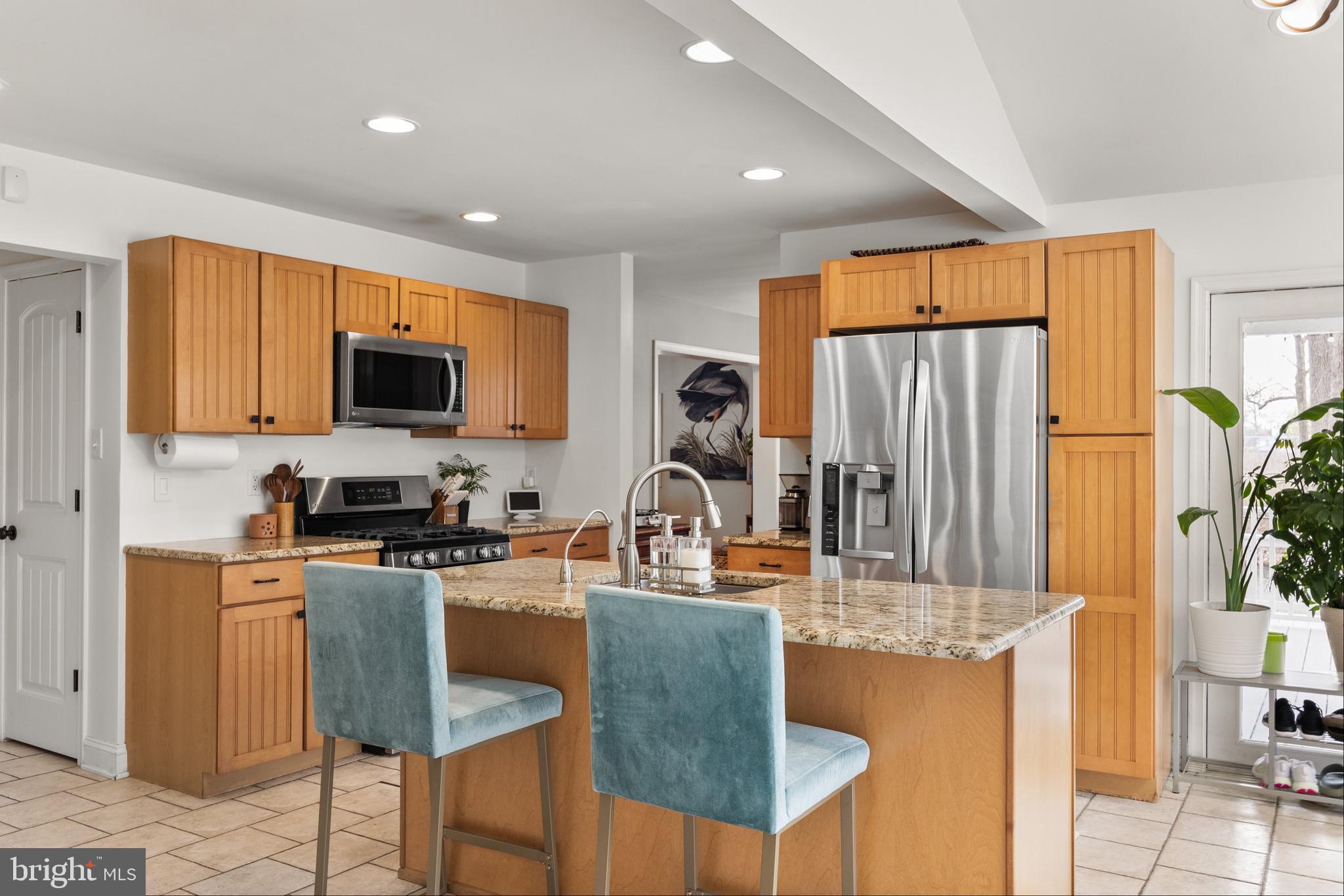 13 Mallard Drive Tabernacle, NJ 08088 - Photo 12 of 54 a kitchen with granite countertop a table chairs microwave and refrigerator