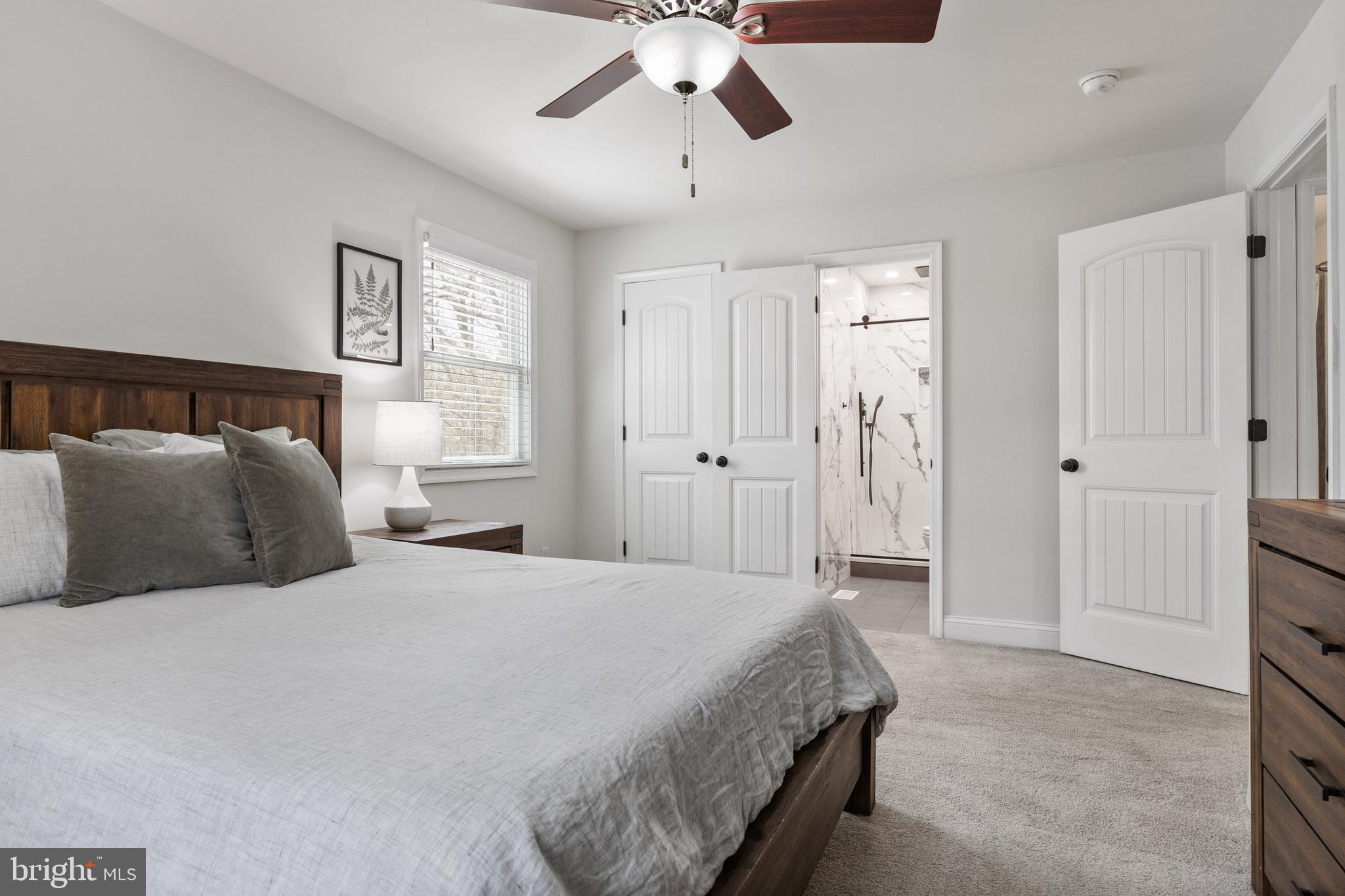 13 Mallard Drive Tabernacle, NJ 08088 - Photo 21 of 54 a spacious bedroom with a bed and a chandelier