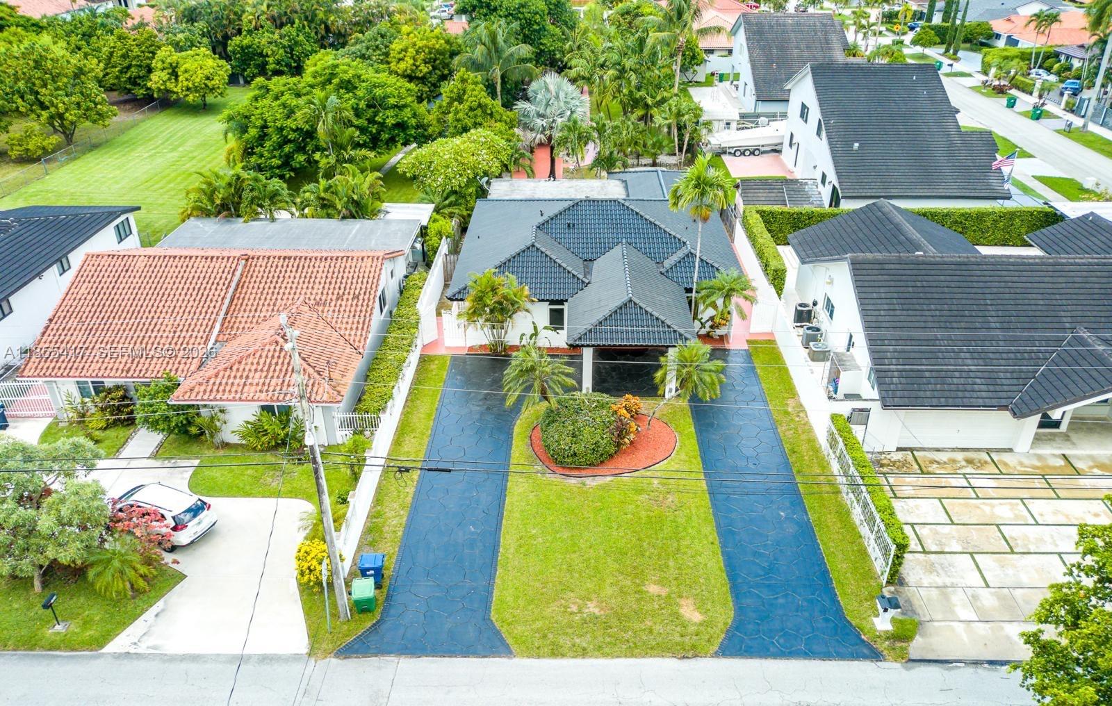 2810 Southwest 114th Avenue Miami, FL 33165 - Photo 1 of 62 an aerial view of a house with swimming pool and large trees