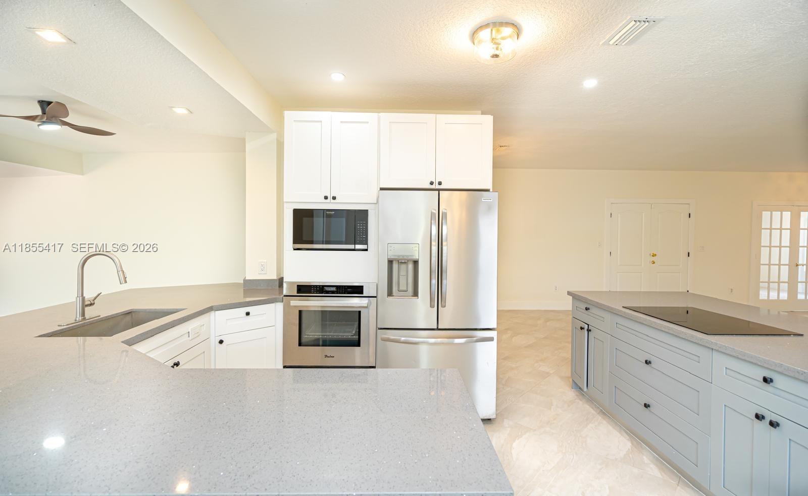 2810 Southwest 114th Avenue Miami, FL 33165 - Photo 15 of 62 a kitchen with granite countertop a refrigerator and a sink
