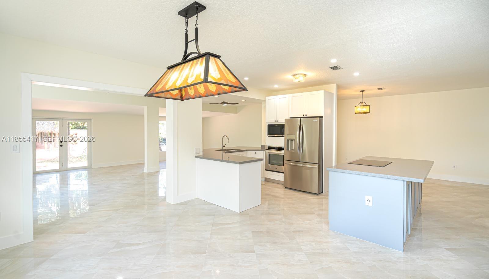 2810 Southwest 114th Avenue Miami, FL 33165 - Photo 19 of 62 a view of a kitchen with refrigerator and wooden floor