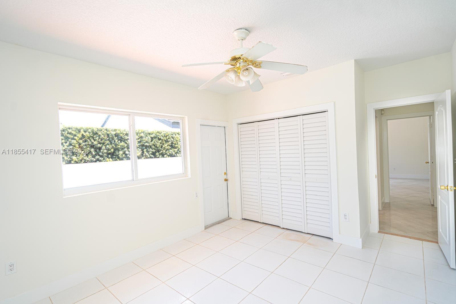 2810 Southwest 114th Avenue Miami, FL 33165 - Photo 47 of 62 an empty room with windows and fan