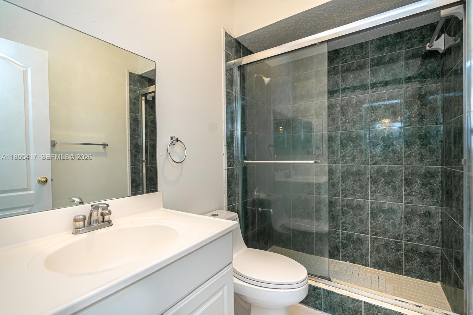 2810 Southwest 114th Avenue Miami, FL 33165 - Photo 57 of 62 a bathroom with a sink toilet and shower