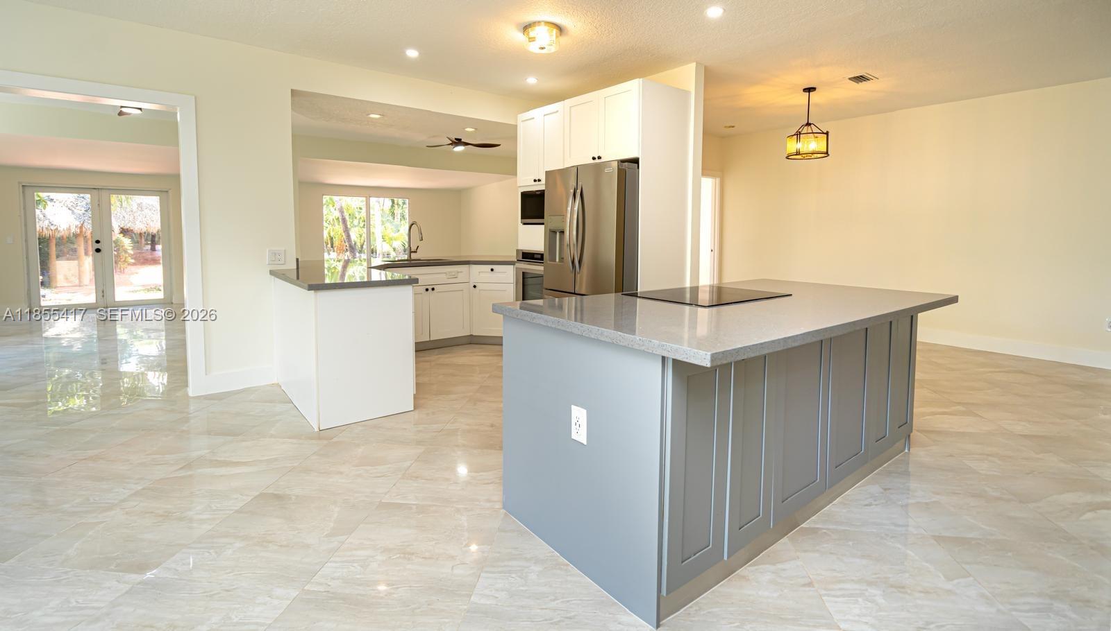 2810 Southwest 114th Avenue Miami, FL 33165 - Photo 8 of 62 a kitchen with kitchen island cabinets and refrigerator