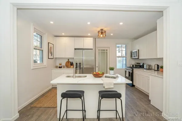 a large kitchen with a table and chairs