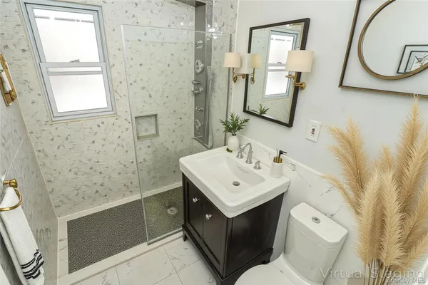 a bathroom with a sink a toilet and mirror