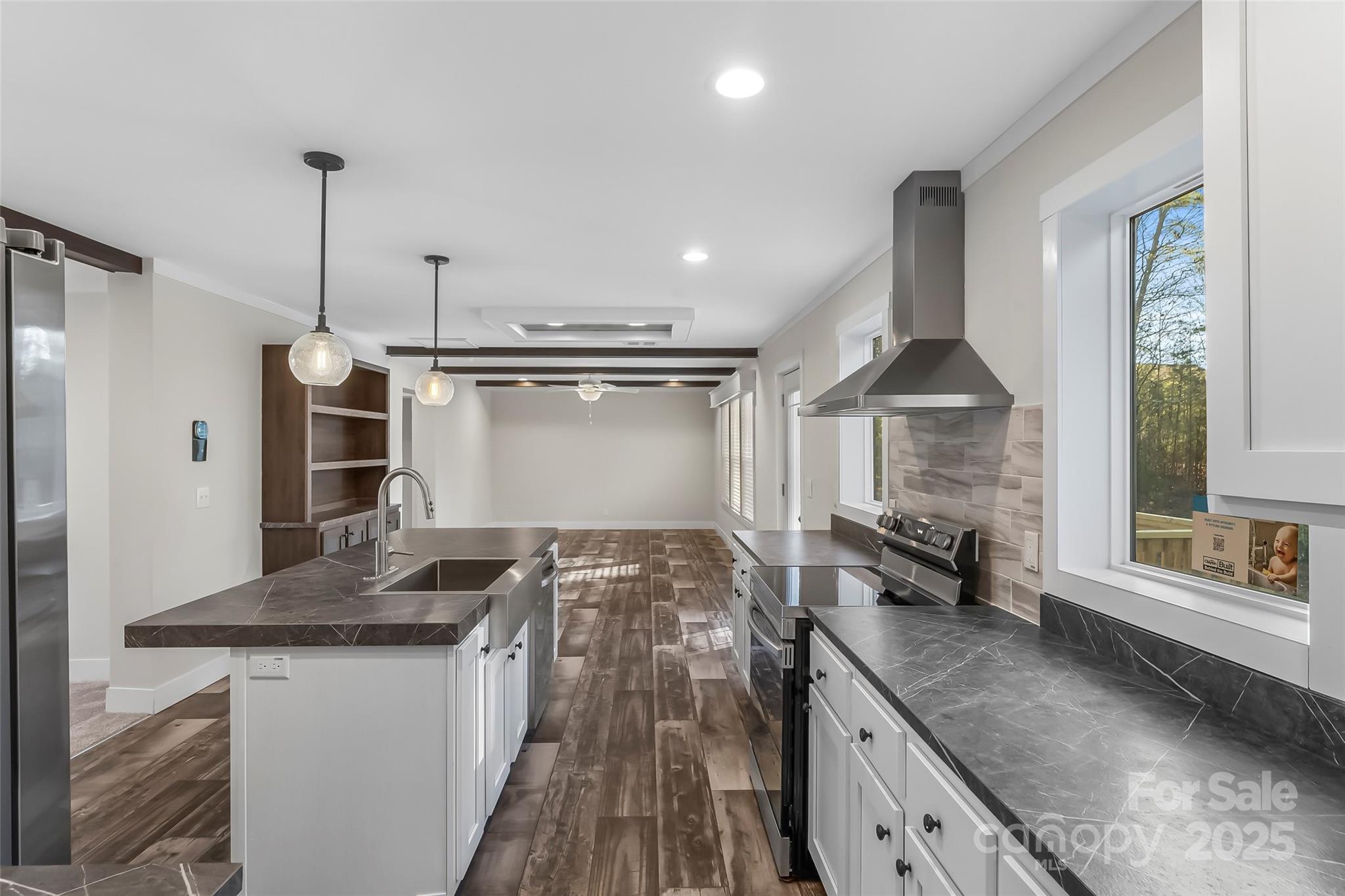 209 Walnut Br Road Weaverville, NC 28787 - Photo 11 of 43 a kitchen with kitchen island granite countertop a sink and a stove