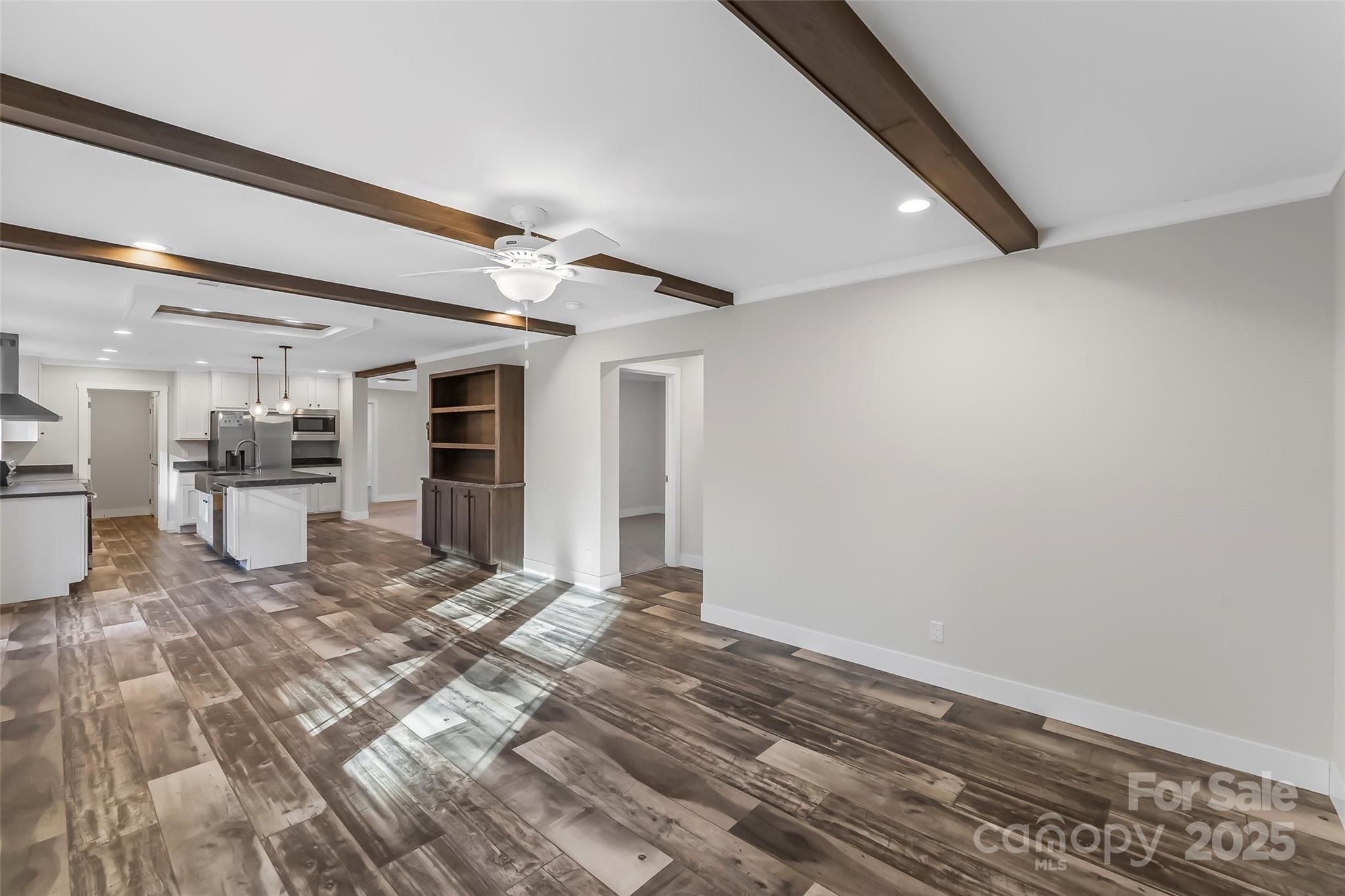 209 Walnut Br Road Weaverville, NC 28787 - Photo 16 of 43 a view of a livingroom with wooden floor and a kitchen