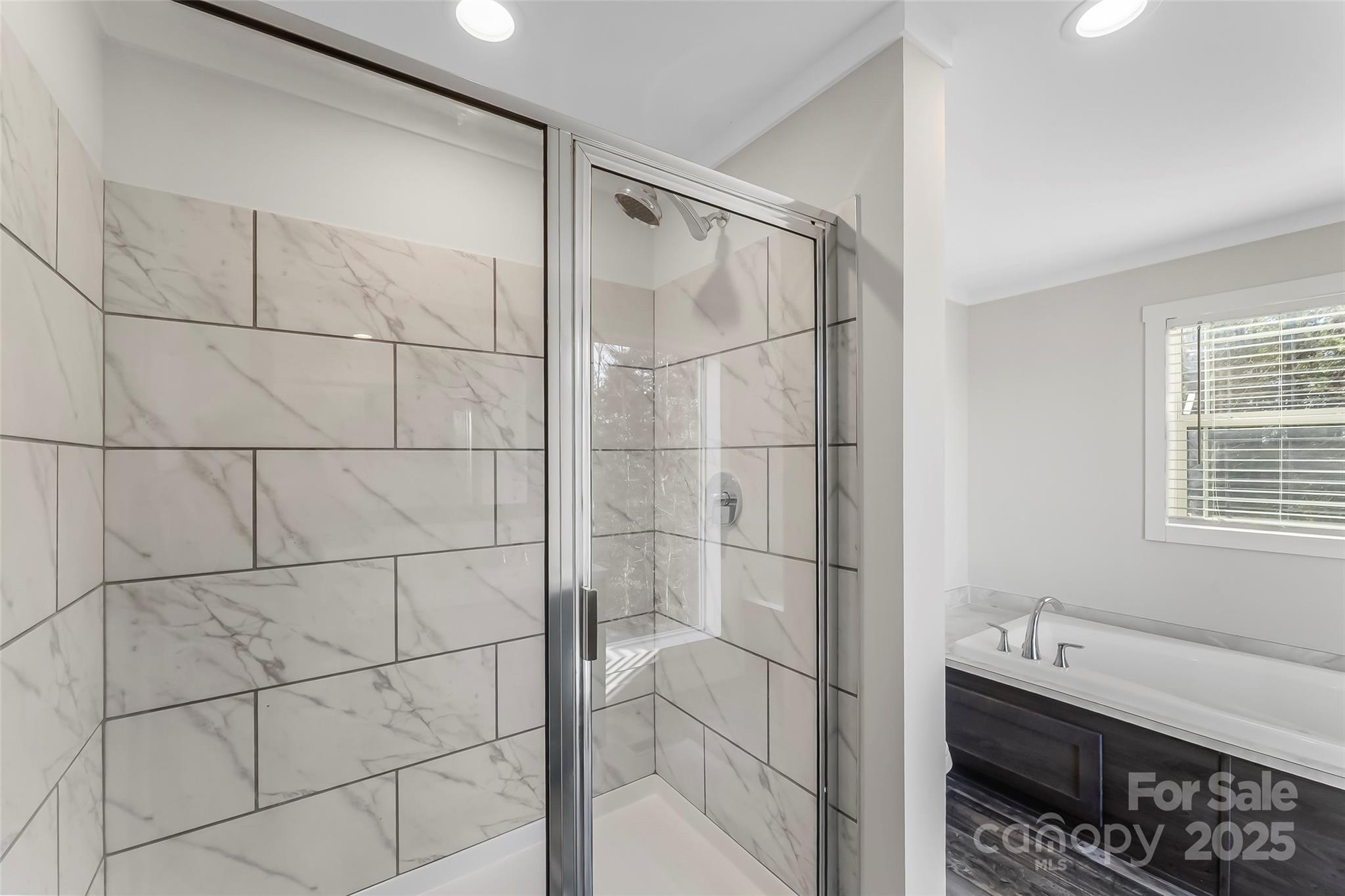 209 Walnut Br Road Weaverville, NC 28787 - Photo 24 of 43 a bathroom with a double vanity sink and a shower