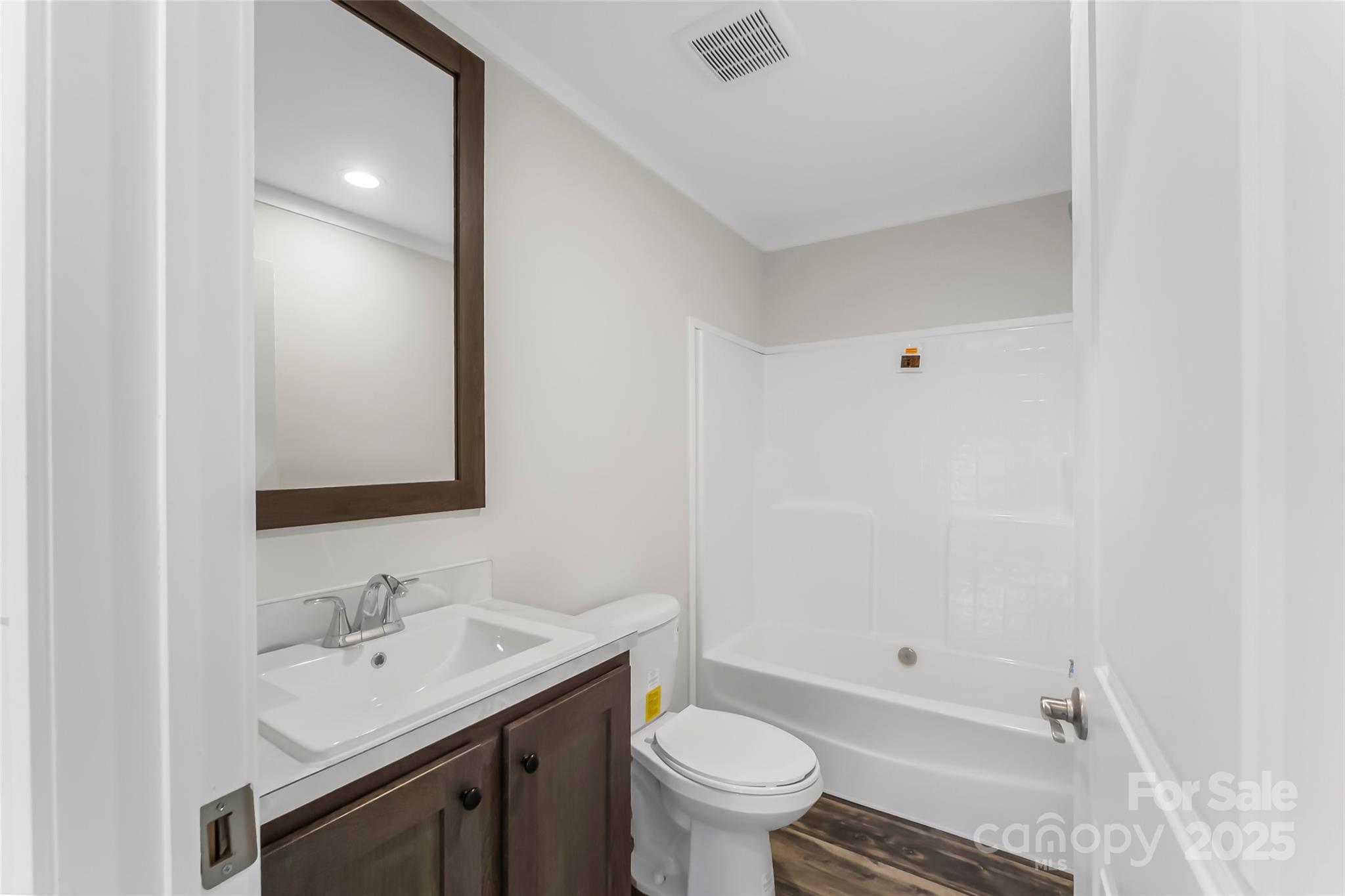 209 Walnut Br Road Weaverville, NC 28787 - Photo 29 of 43 a bathroom with a sink toilet vanity and tub