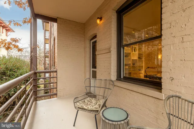 a living room with furniture a chandelier and a dining table