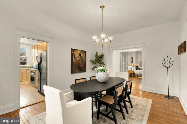 a kitchen with stainless steel appliances granite countertop a refrigerator a stove a sink dishwasher and microwave oven with wooden floor