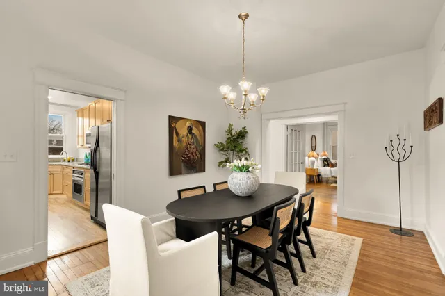 a kitchen with stainless steel appliances granite countertop a refrigerator a stove a sink dishwasher and microwave oven with wooden floor