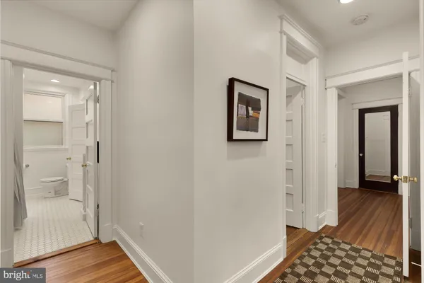 a bedroom with a bed a bookshelf and a potted plant