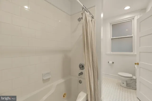 a bedroom with furniture and a rug