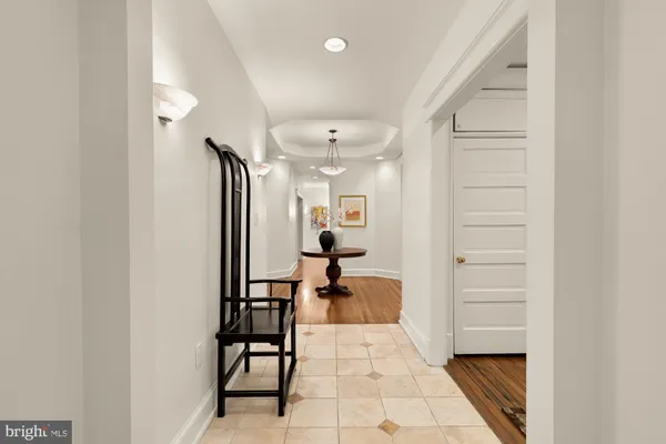 a living room with couch and a chandelier