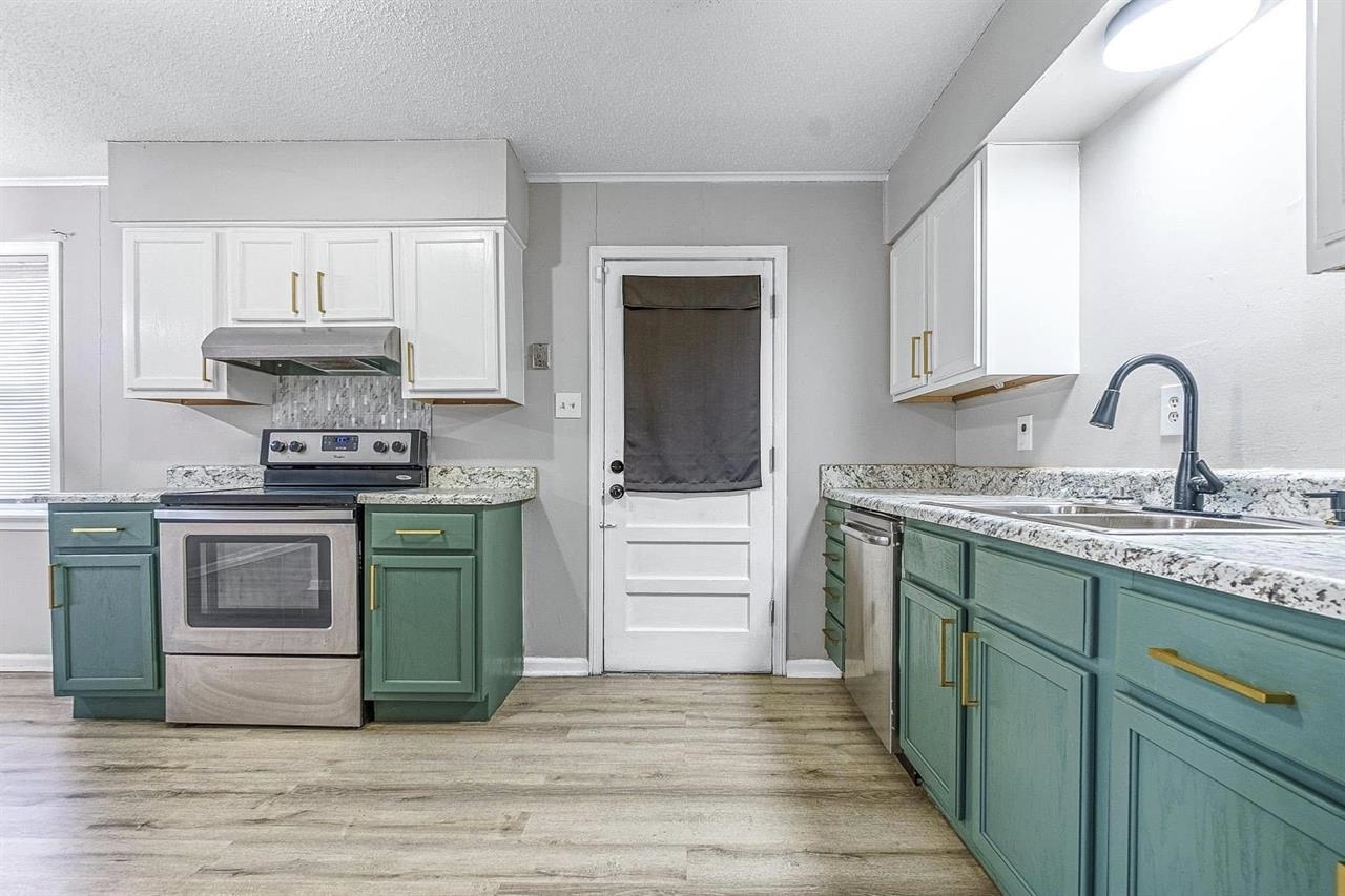 3837 Tessland Road Memphis, TN 38128 - Photo 4 of 12 a kitchen with granite countertop a stove and a sink