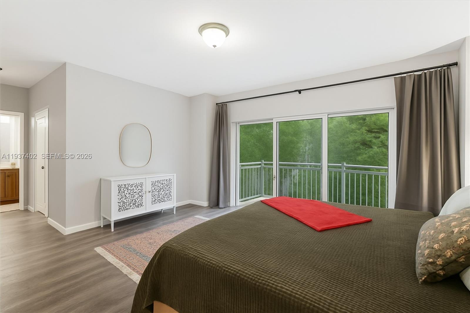 2730 Southwest 26th Street, Unit 2730 Miami, FL 33133 - Photo 11 of 21 a bedroom with a bed a closet and mirror